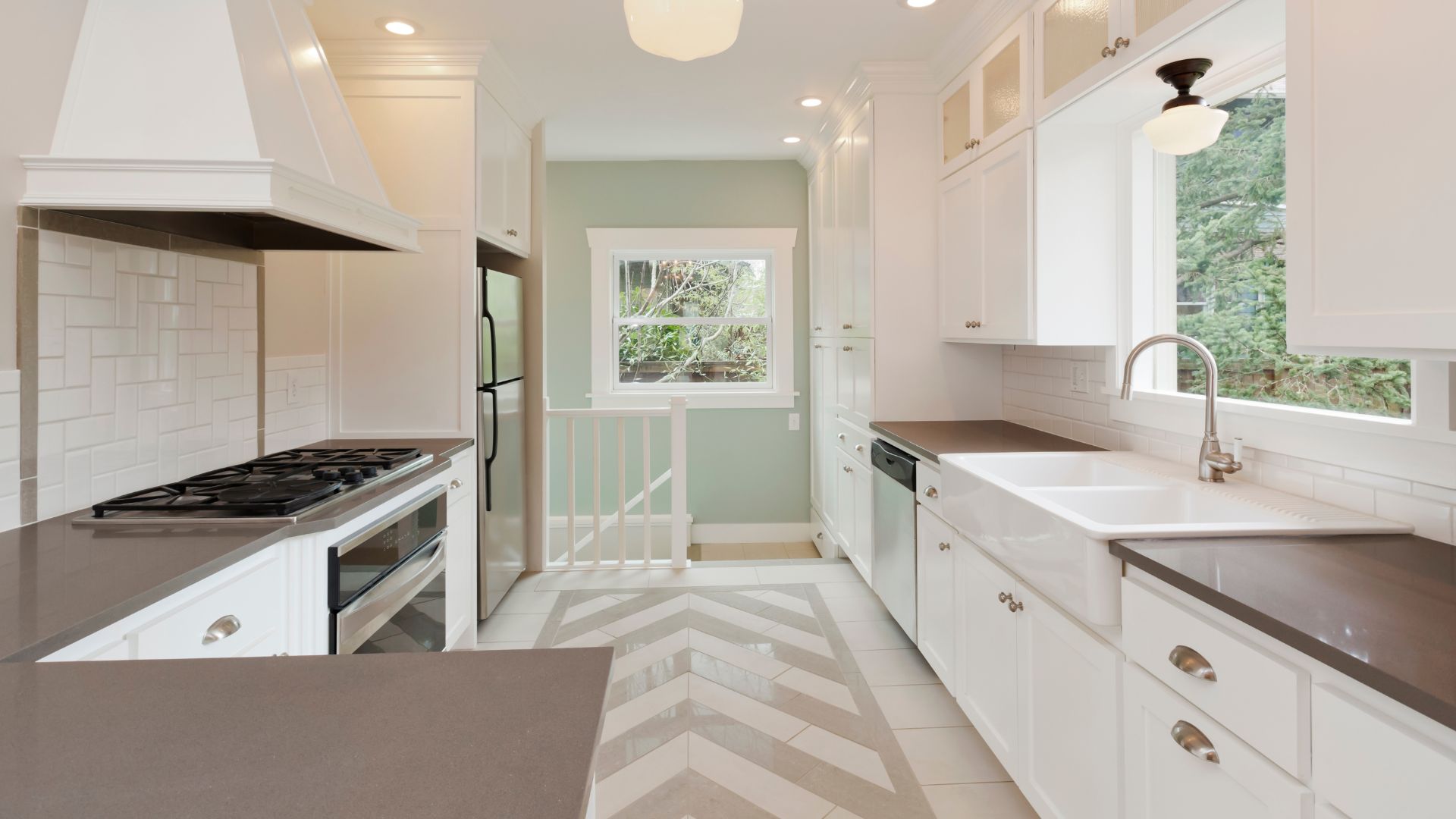 A kitchen with a stove top oven sitting next to a sink