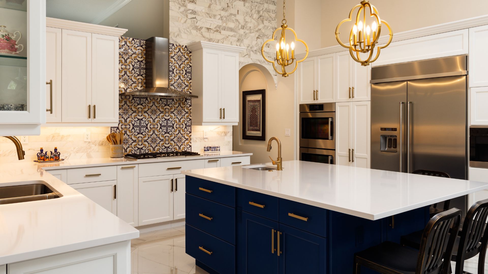 A kitchen with white cabinets and a blue island