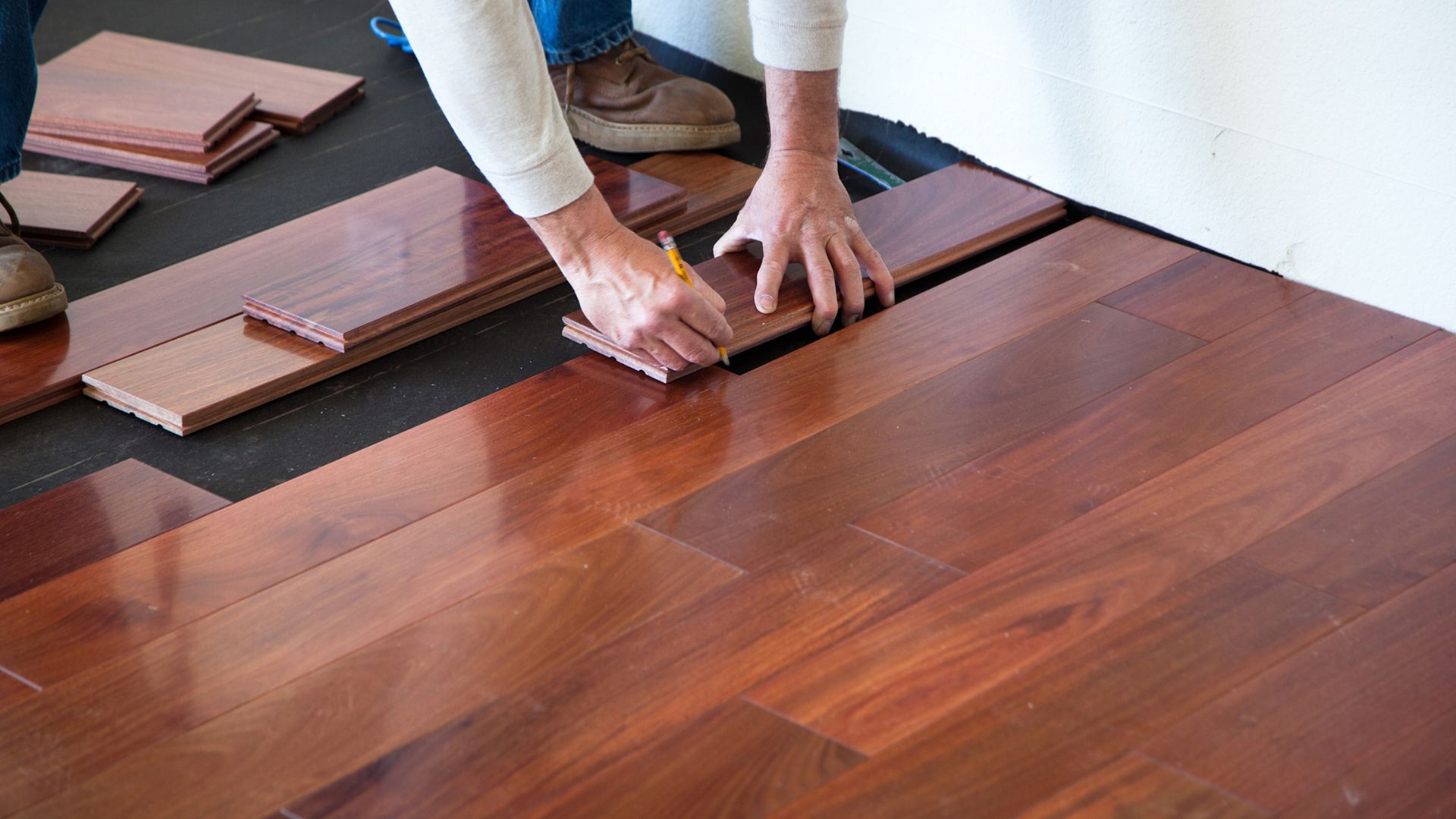 A person is working on a wooden floor